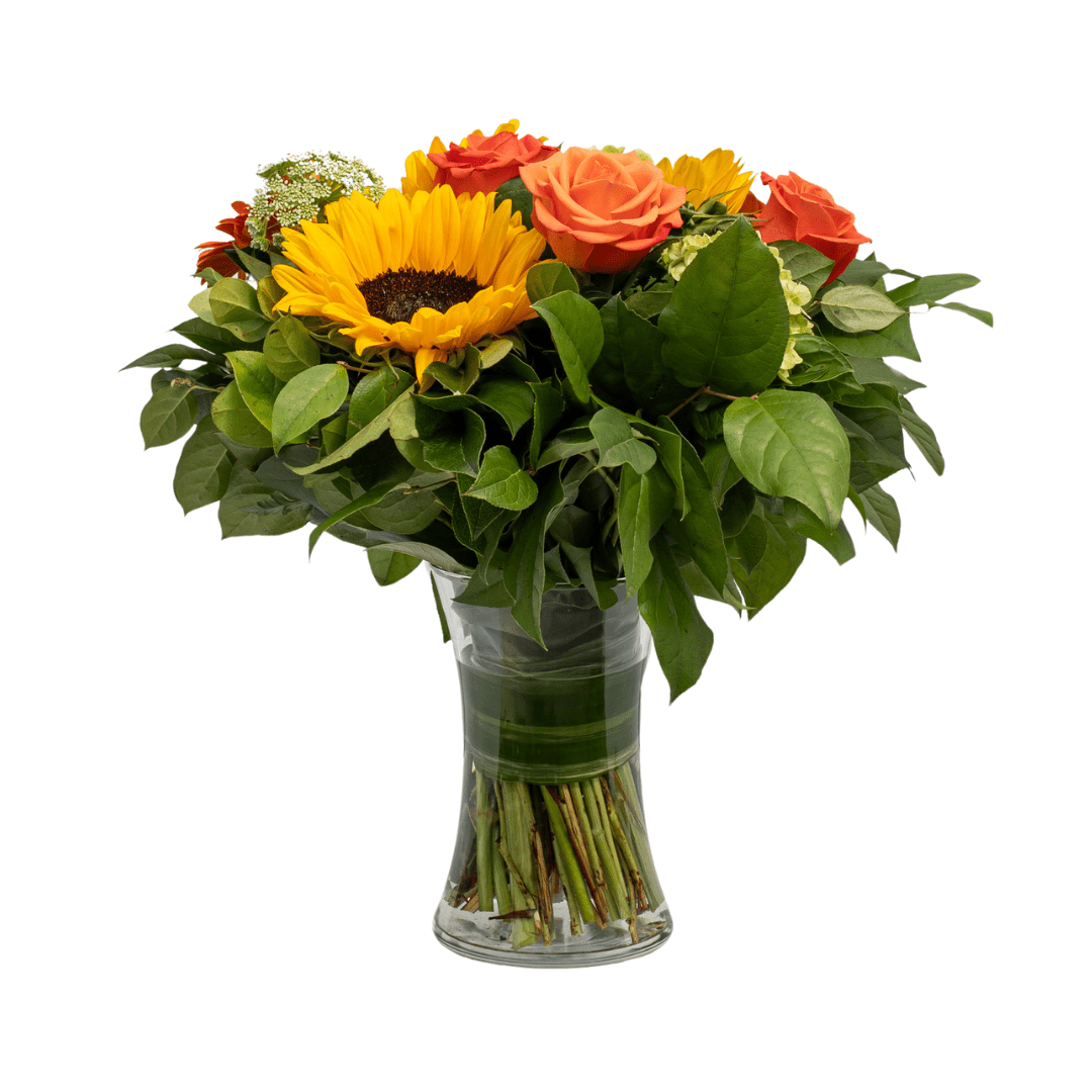 Vibrant floral arrangement with sunflowers, roses, and green leaves in a glass vase, perfect for any occasion.