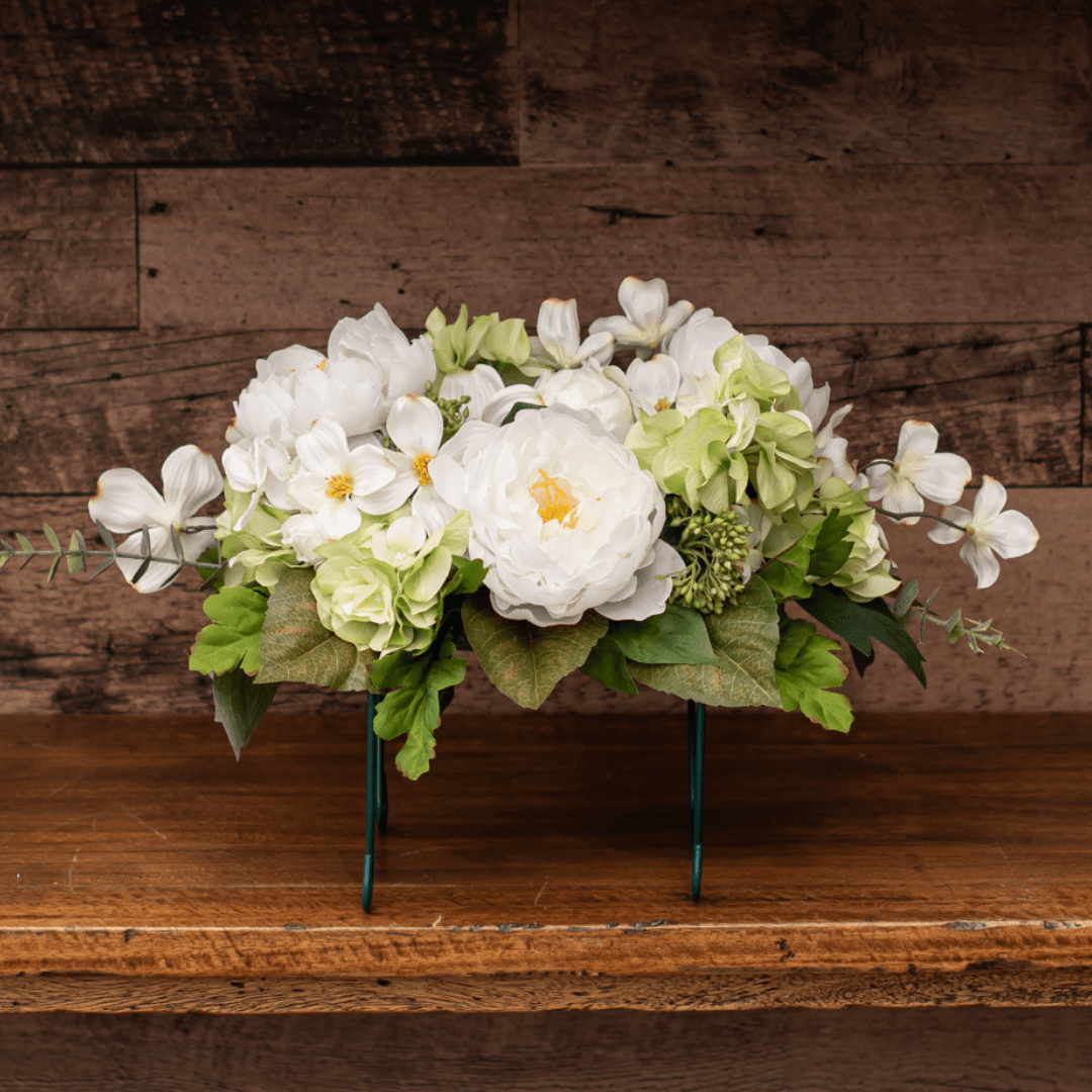 184 Elegant white floral arrangement on rustic wooden table.