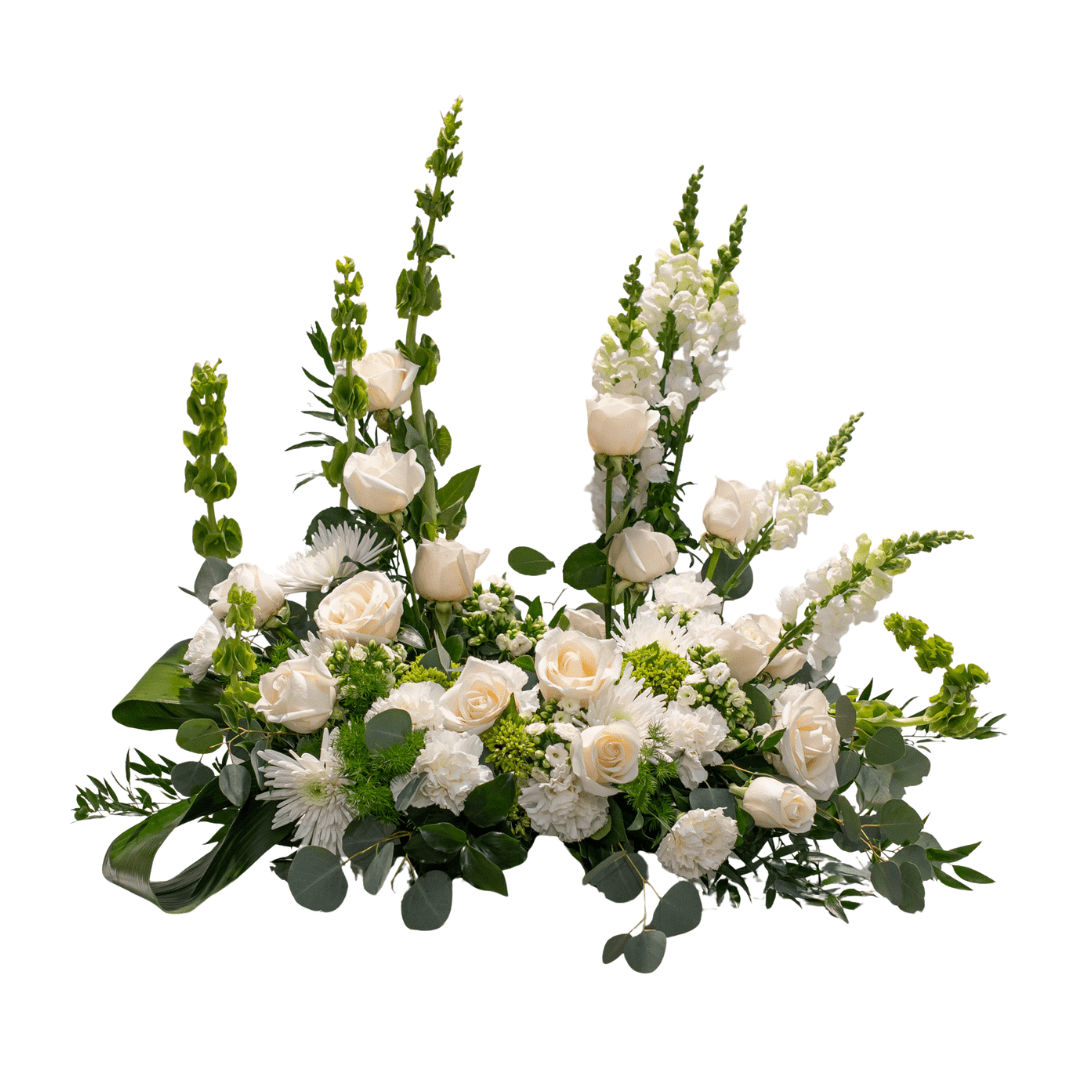 27 Elegant floral arrangement with ivory roses, white snapdragons, and lush greenery, perfect for weddings or celebrations.