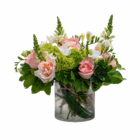 Elegant floral arrangement featuring pink roses, white freesias, and greenery in a clear vase. Ideal for spring decor.