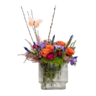 Colorful flower arrangement with orange roses, purple blooms, and butterfly in a clear vase. Elegant and vibrant decor.