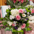 Bouquet of pink roses, white hydrangeas, and purple flowers, ideal for weddings or special occasions.