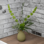 Fresh greenery and dried eucalyptus pods in an olive-coloured textured vase with two small decorative handles on the side. It sits on dark wood flooring with white and grey bricks behind it.