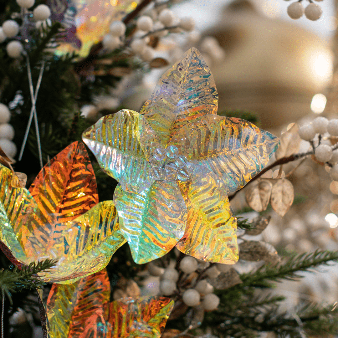 An iridescent flower pick in an artificial green Christmas tree.