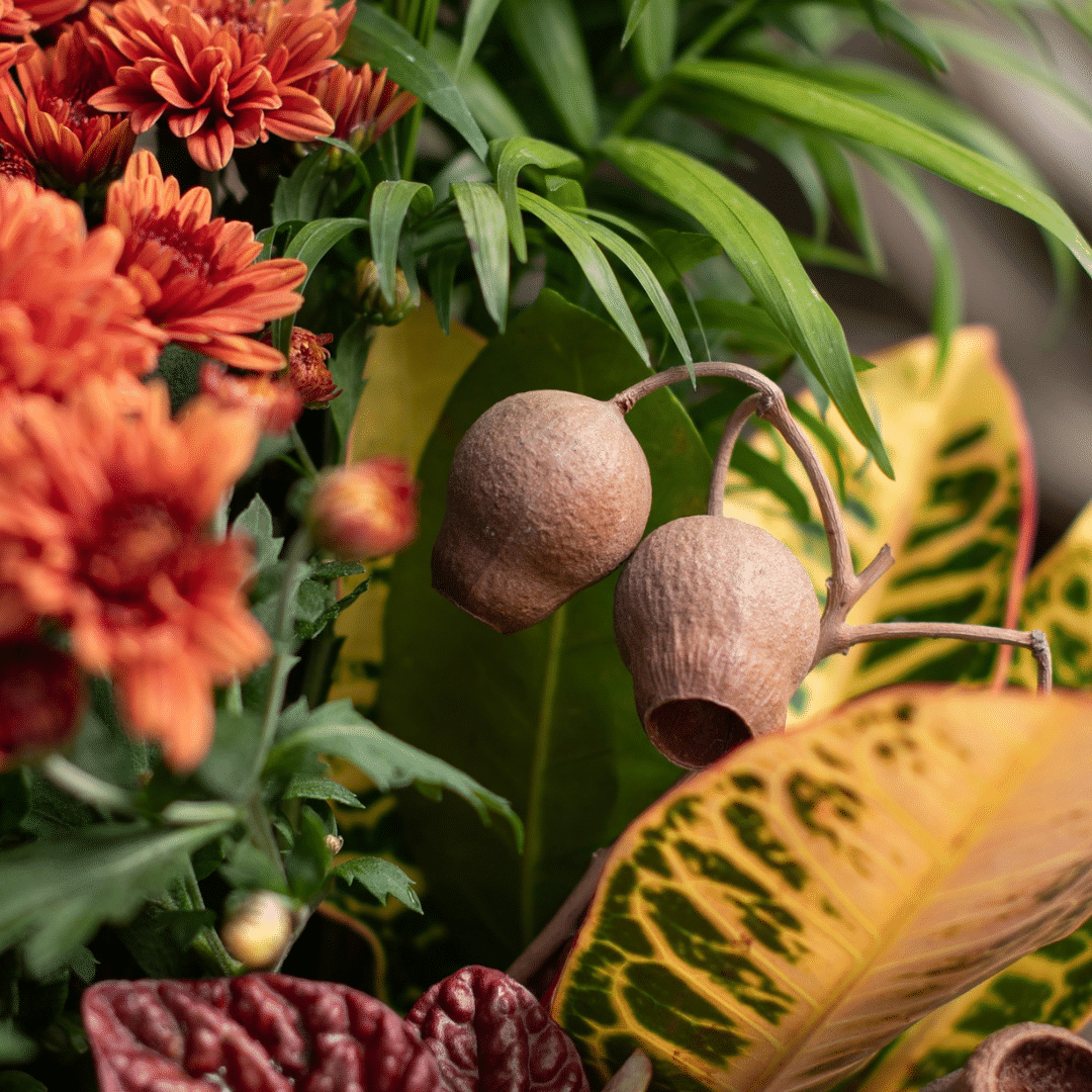 A close-up of silk bell cups in a fall-themed indoor mixed planter.