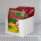 Red, green, and yellow plastic packages of Lawn Guardian nematodes sit in a white cardboard display on a white metal shelf in a cooler.