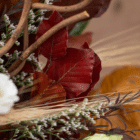 A close-up of rust-coloured leaves in a fall floral arrangement.
