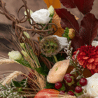 A close-up of a brown starflower in a fall floral arrangement.