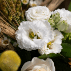 A close-up of white lisianthus blooms in a floral bouquet.