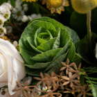 A close-up of green ornamental kale in a floral bouquet.