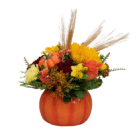 A floral arrangement in an orange ceramic pumpkin with sunflowers, yellow freesia, orange roses, etc.