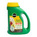 Miracle-Gro Shake 'n Feed all-purpose plant food container with yellow cap and organic label.